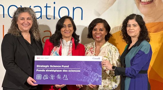 Four women holding a banner