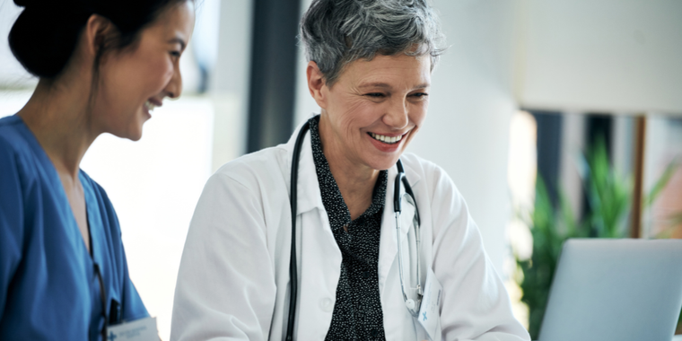 Healthcare professionals looking at a laptop