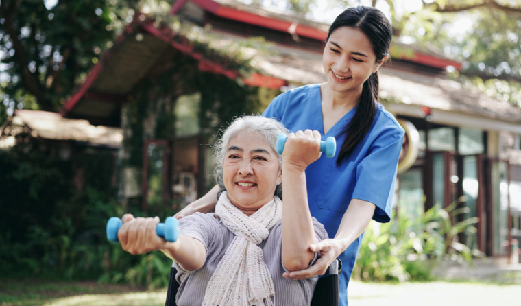 Caregiver with older person exercising