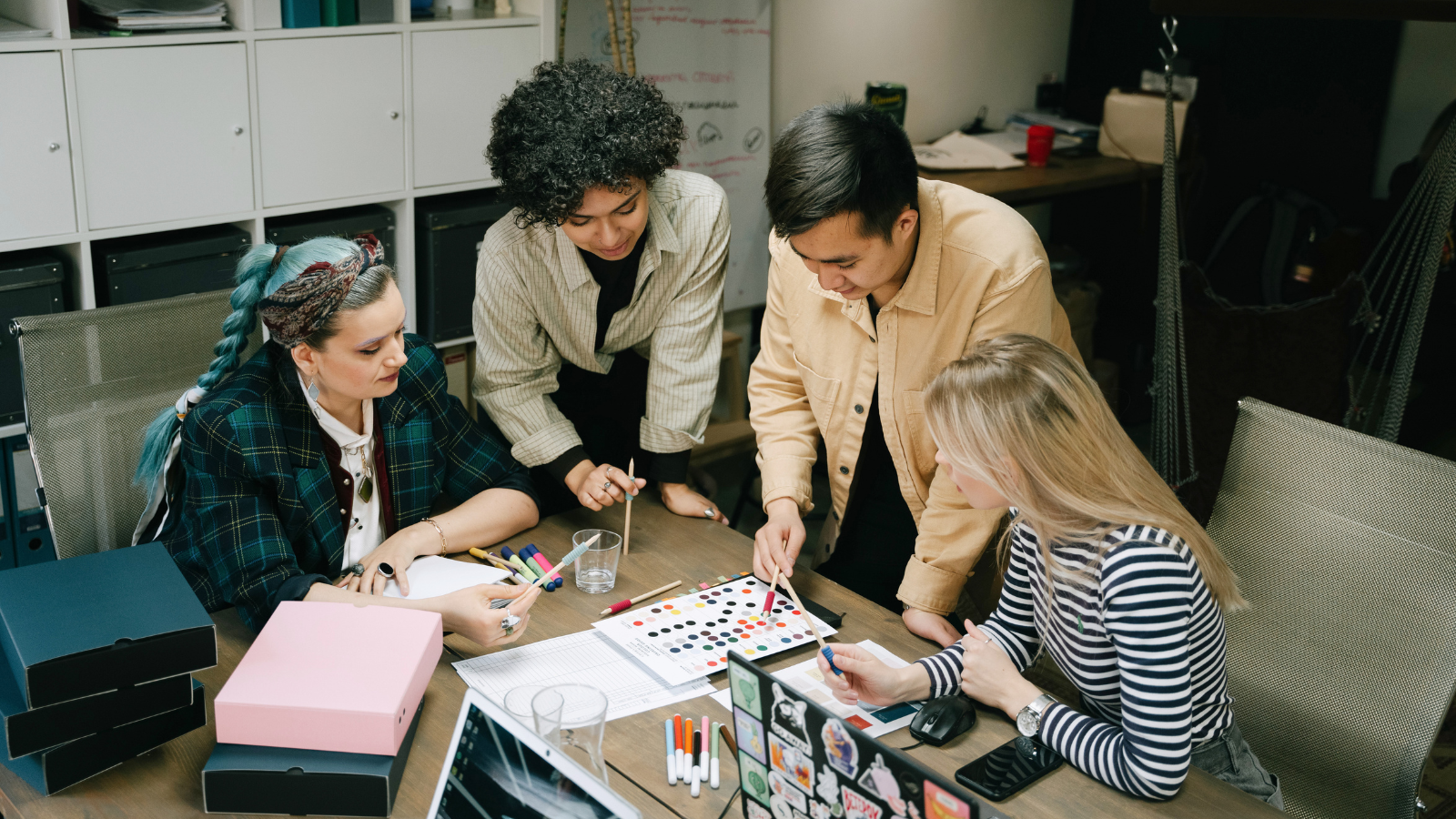 Young professionals huddled around a project